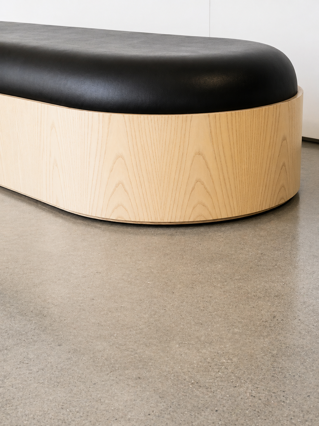 Detail of the matched white ash veneer and upholstered top on the Nike pill bench